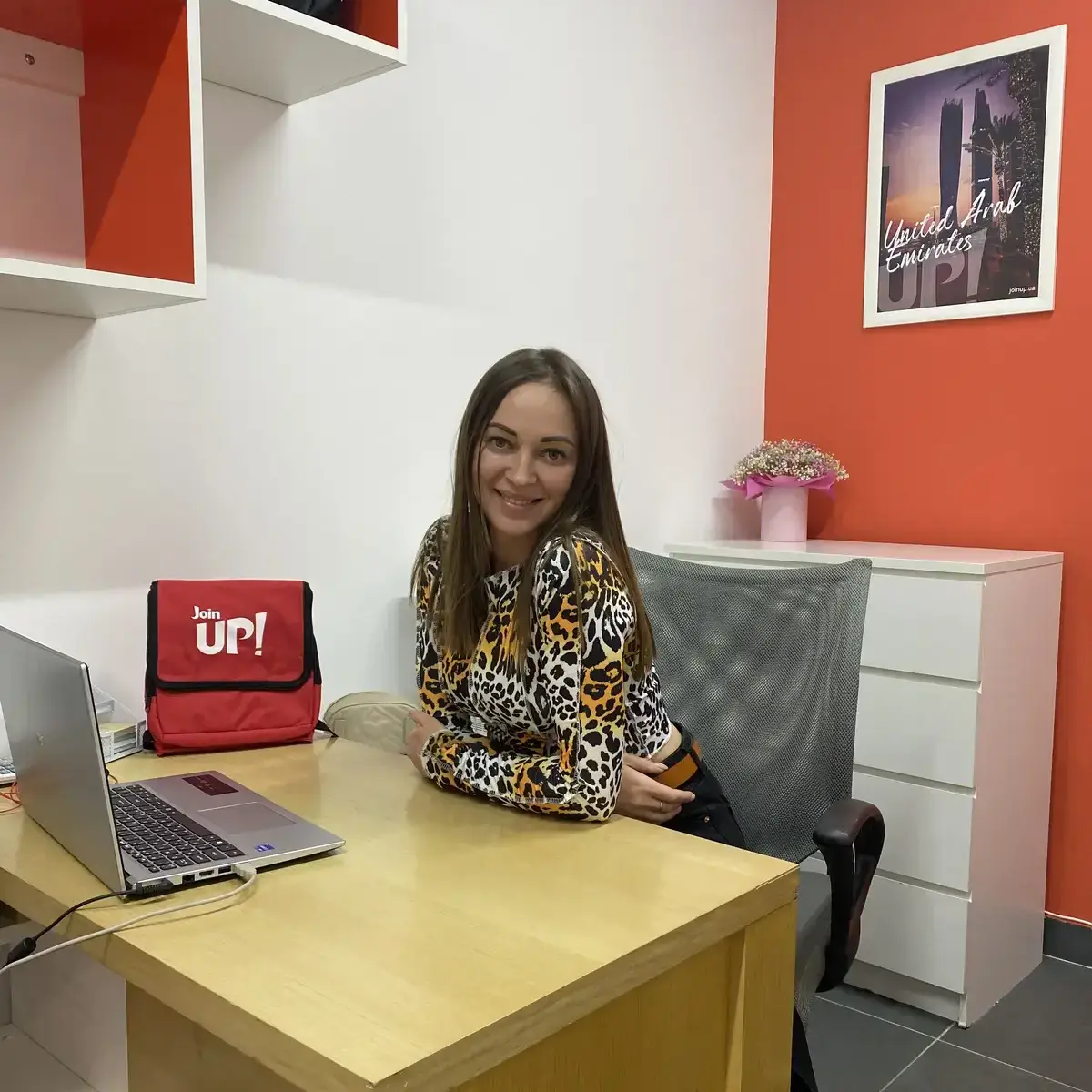 A smiling girl sitting at the table in the Join UP office!