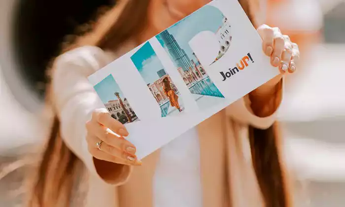 The girl is holding a gift certificate from Join UP!